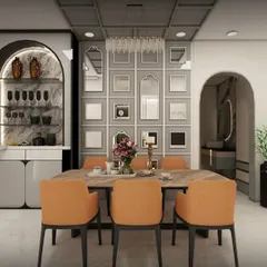 A sophisticated dining room featuring a custom-built bar and crockery unit with an arched design. The space is tied together with a grid of mirrors on the feature wall, adding depth and reflecting the light from the elegant chandelier.