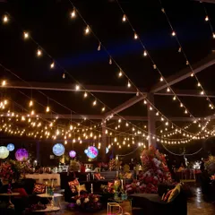 A celestial-themed lounge area under a canopy of fairy lights. The hanging planet-like orbs and custom zodiac-printed carpets created a magical, otherworldly vibe for the after-party.