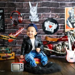 Born to be wild! This little dude is rocking his leather jacket and cool attitude in our fun, rock-and-roll themed studio setup.