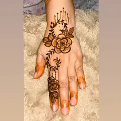 A beautiful and delicate rose vine design on the back of the hand. This kind of jewelry-like henna is perfect for proms, parties, or just a day you want to feel special.