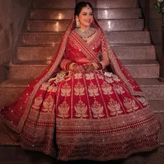The smile of a happy bride says it all. This look features a classic bridal updo, subtle contouring, and a radiant complexion that glows with happiness, perfect for a traditional Hindu wedding.