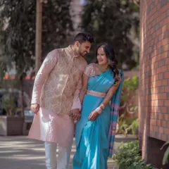A beautiful, candid moment of a couple walking hand-in-hand, dressed in elegant ethnic wear for their engagement session.