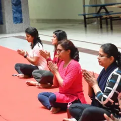 Participants in a corporate yoga session are seen here in a moment of quiet reflection. Even a short session can create a peaceful atmosphere and help team members connect with themselves.