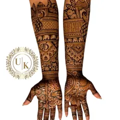 A beautiful example of a traditional Rajasthani bridal design. The artwork is dense with classic motifs like peacocks, elephants, and the couple's initials, creating a rich and royal look.