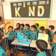 A teacher demonstrates a water purification model to a group of curious students during a 'Sciscape' activity. We make science concepts tangible and easy to understand.