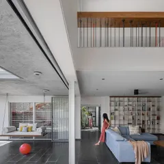 We believe a home should embrace the entire family, including pets. In our 'Maya House' project, the living room's sliding glass walls completely open up to the garden and patio swing, creating a seamless indoor-outdoor living area for everyone to enjoy together.