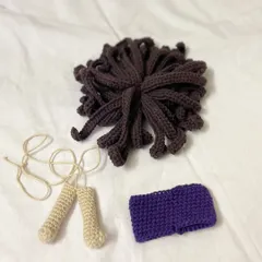 The beginning of a surfer doll named Tabias. This photo shows his legs, a purple headband, and his unique brown hair, all waiting to be assembled.