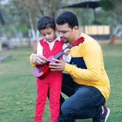 A father teaching his son how to play the guitar is a memory worth saving. I love capturing these teaching moments between parents and children during our family photoshoots.