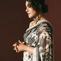 The profile view highlights the intricate patterns of this Torani saree and the soft, elegant hairstyle chosen for this look.