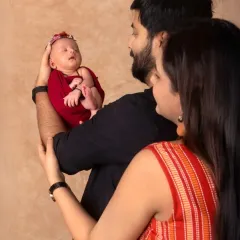 A beautiful first family portrait. The parents gaze at their newborn with so much love and wonder. A truly priceless moment.