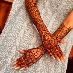 I love personalizing mehandi for my clients. This design incorporates the couple's initials "D" and "S" into the palms, surrounded by classic patterns for a modern yet traditional feel.