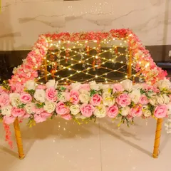 For a touch of sparkle, this phoolon ki chadar is interwoven with delicate fairy lights. The pink and white artificial flowers combined with the warm lights create a magical effect, perfect for an evening bridal entry.