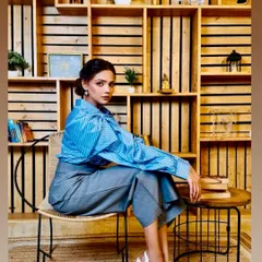 For this corporate fashion shoot, the goal was a look that felt powerful and polished. I focused on clean lines, subtly defined eyes, and a neutral lip to complement the 'power dressing' theme, ensuring the makeup enhanced the model's confident presence without overpowering the clothing.