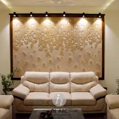 "Everything is designed. Few things are designed well." This living area features a custom CNC-carved stone panel, spot-lit to create a dramatic and artistic backdrop for the main seating area.