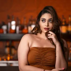 A sophisticated evening look for a photoshoot. The makeup features a dramatic winged eyeliner, contoured cheeks, and a classic red lip, creating a timelessly glamorous vibe.