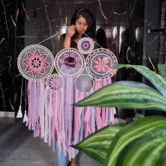 This large pink cluster dreamcatcher, personalized with the name 'Meenal', is designed to radiate positivity. Its balance of warmth and elegance creates a cozy and inspiring atmosphere on any wall.