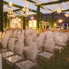 We love mixing modern eclecticism with traditional charm. Here, we paired modern ghost chairs with grand 'Umrao Jaan' style chandeliers and pillars wrapped in greenery, proving that opposites really do attract.