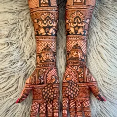 A grand design featuring peacocks, elephants, and architectural domes. This is a royal look, perfect for a bride who wants to feel like a queen.