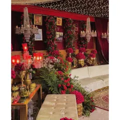 This seating area was part of a grand reception with a red romantic theme. We used cascading red flowers, crystal chandeliers, and golden decor pieces to create a luxurious space for guests.