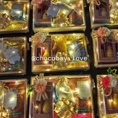 These wooden gift hampers are a fantastic option for return gifts. Lit with fairy lights, they contain a mix of snacks, dry fruits, and decorative items, all beautifully arranged in a pinewood tray.