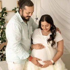 The couple shares a quiet moment, both connecting with the baby. I guide my clients into poses that feel natural and highlight their bond.