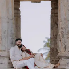 An intimate and tender moment between the couple, framed by the temple's stone pillars. This photo focuses on the emotional connection and quiet anticipation of parenthood.