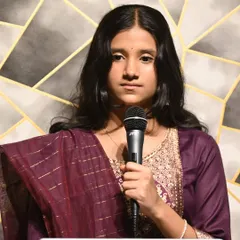 A young student delivering a focused performance. We train students from a young age to be comfortable and poised on stage.