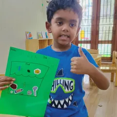 A big thumbs-up for science. After our experiment, this little Aster is excited to show off his completed float and sink activity sheet, correctly identifying which items belong in the water and which go to the bottom.