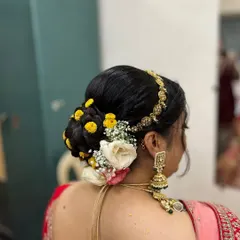 You can never go wrong with a floral bun. This classic hairstyle is perfect for weddings and traditional events, adding a touch of grace and elegance.