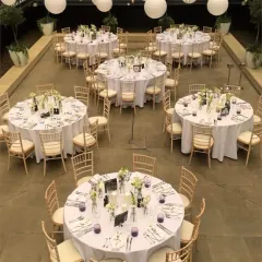 An elegant terrace decoration for a home wedding. We used round tables with white linens, classic Chiavari chairs, and hanging paper lanterns to transform the space into a beautiful celebration venue.