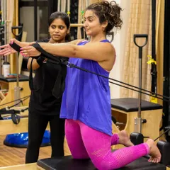 Our trainer provides support and guidance as a client works on her upper body and core strength. This attentive coaching helps build confidence and ensures every exercise is performed with perfect technique.
