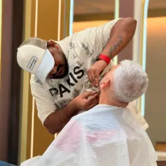 We believe grey hairs are highlights of wisdom. Our stylist provides a careful beard trim for a distinguished gentleman, ensuring a neat and respectable look.
