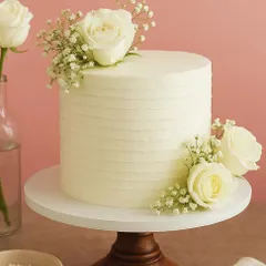 Minimalist design, maximum love. This simple and elegant single-tier cake with fresh white roses is perfect for an intimate engagement celebration or anniversary.