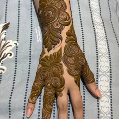 A classic example of a bold Gulf-style henna strip. The design features large, shaded spirals and leaves, creating a powerful pattern that is not overly dense.