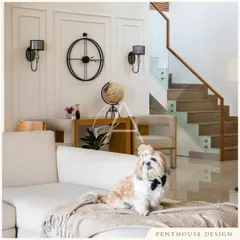 Even our furry friends approve of the cozy atmosphere. This living room combines a comfortable sofa, soft textures, and classic decor elements like the wall sconces and globe for a timeless, inviting feel.