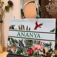A stunning personalised suede tote bag featuring a jungle animal print with zebras, flamingos, and parrots. We've customised it with the name 'Ananya'.
