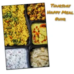 This thali includes a fragrant masala pulav, cooling raita, paneer in a light yellow gravy, dry gobi sabzi, and a comforting suji halwa.