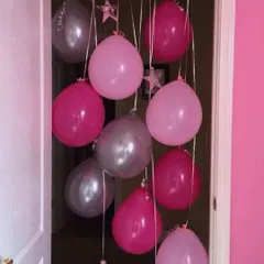 A simple yet effective way to mark a celebration is with a balloon curtain. This pink and silver arrangement is perfect for a doorway surprise for a birthday or baby shower.