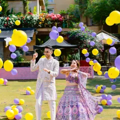 A playful moment with balloons raining down on the couple during their vibrant Haldi celebration in Lonavala. Pure, unadulterated fun.