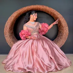 A bride seated, showcasing her elegant high ponytail. This hairstyle is perfect for a long event as it keeps the hair securely off the neck and shoulders.