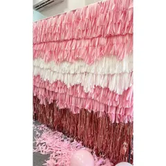 This image shows a close-up of the meticulous detail in our hand-built fringe wall. Each strip is placed to create a textured, multi-layered effect, which took over 24 hours to construct for this first birthday party.