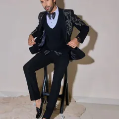 This shot showcases a complete look for a men's fashion shoot. The makeup is undetectable, simply enhancing the model's natural features and ensuring there's no distracting shine on the skin.