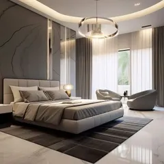 A luxurious master bedroom featuring a marble accent wall, a curved false ceiling with cove lighting, and a modern ring chandelier. The space includes a comfortable seating area by the window, creating a suite-like feel with high-end finishes.
