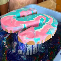 The magic of fluid art in action. This close-up shows the incredible moment when colors meet and marbleize on a wooden letter. It's a mesmerizing process that is just as fun as the beautiful result.