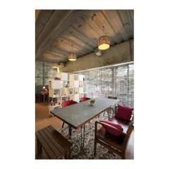A large conference table designed for our studio's gallery space. The piece features a raw, form finished concrete top set on minimalist steel legs, showcasing our work with industrial materials for commercial and office environments.