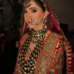 A close-up that captures the intensity and beauty of her bridal makeup. The smokey eye, flawless skin, and traditional nath come together for a powerful and unforgettable look.