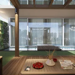 This perspective from the seating area looks out over the pool towards the apartment's interior, showing how our designs create a seamless flow between indoor and outdoor living spaces.