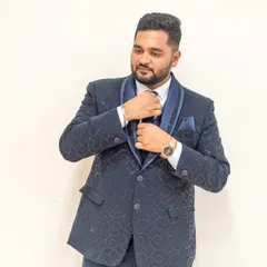 A polished reception look for the groom. The focus is on creating a natural, shine-free finish that enhances his features for professional photography.
