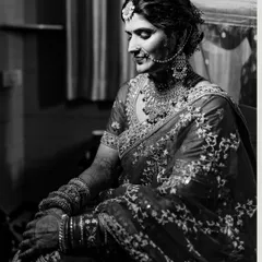 I love using black and white to create dramatic and timeless portraits. This image of a North Indian bride captures a moment of quiet reflection, with the monochrome tones emphasizing the rich embroidery of her lehenga.