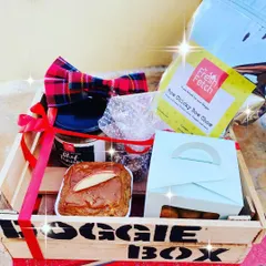 Looking for the perfect gift? My Doggie Box is packed with goodies like a fresh meal, homemade cookies, a grain-free muffin, and even a stylish bow tie to make any pup feel special.